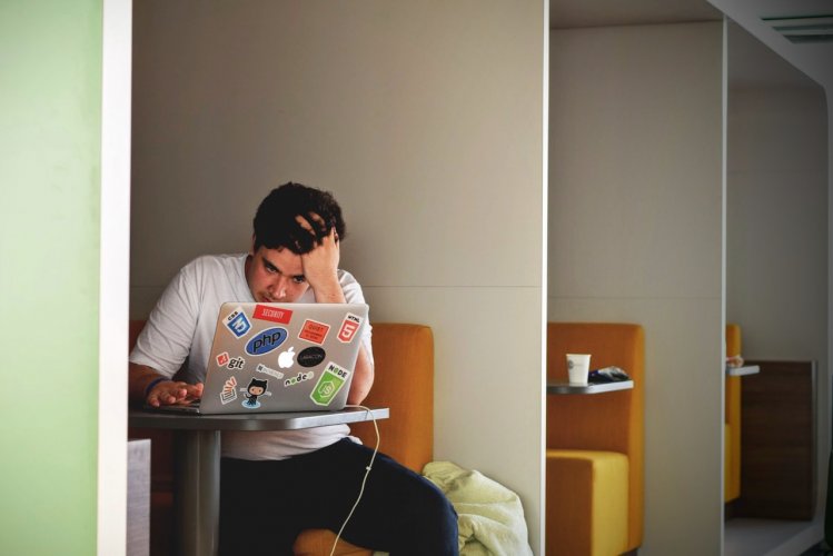 Photo of a student studying with his laptop in a study carel.